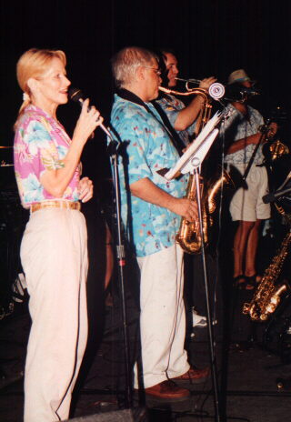 Angie singing in front of the horn section 